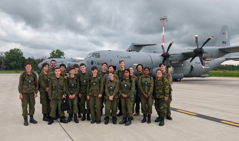 cadets stand in front of a c17